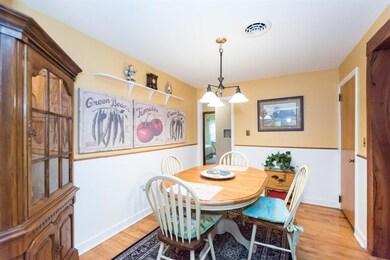 Quaint dining room with wainscoting and hard wood 