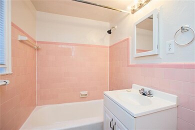 Full bathroom featuring tile walls, shower / washt