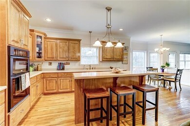 Kitchen features Corian countertops and island wit