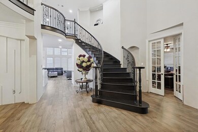 Stairway with wood-type flooring, crown molding, c