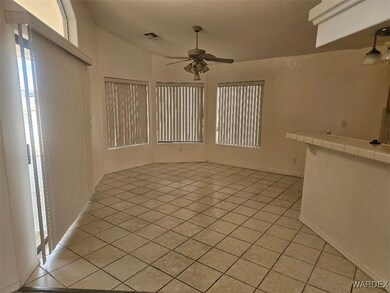 Empty room with vaulted ceiling, a ceiling fan, vi