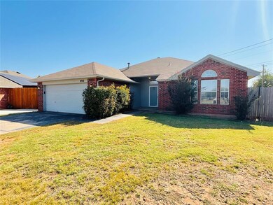 Ranch-style home with a front lawn and a garage