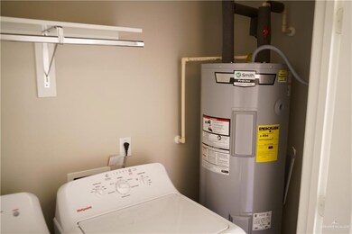 Laundry room featuring water heater and washer / clothes dryer