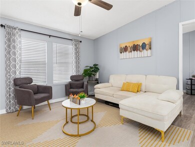 Living room featuring ceiling fan, wood-type floor
