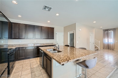 Kitchen featuring a sink, black gas stove, dishwas
