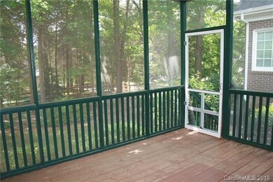 Screen porch overlooking wooded backyard provides 