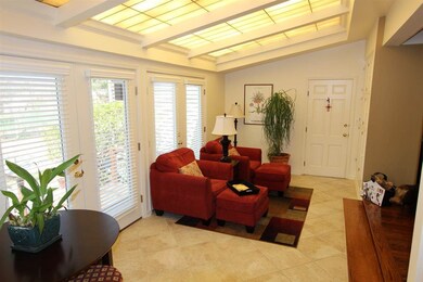 The bright sunroom is the perfect spot to sit and 