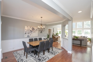 As soon as you open the front door, you will feel the open space offered in this home.  The entry foyer spills into the formal dining area, which is separated from the living space with an attractive architectural feature. The hardwood floors gleam!