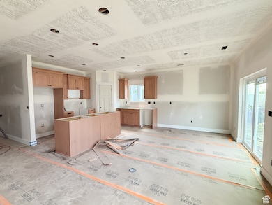 Kitchen featuring baseboards and a kitchen island