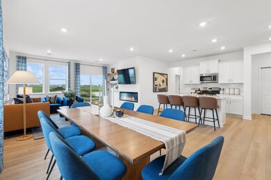 (Photo of decorated model, actual homes colors and finishes will vary) Soaked in natural sunlight, the homes eat-in dining room has ample room for a dining table located in the heart of the home.