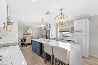 Kitchen with a sink, visible vents, white cabinets