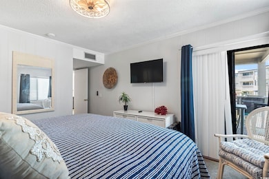 Bedroom with crown molding, carpet, visible vents, and multiple windows