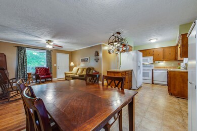 This shot shows a look into the living room and kitchen from the eat in kitchen.