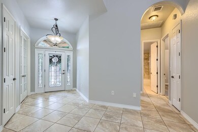 Foyer entrance featuring arched walkways, light t