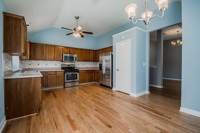 Kitchen featuring backsplash, light countertops, a