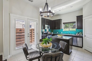 Kitchen with tasteful backsplash, a chandelier, l