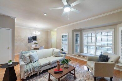 Living area with a chandelier, crown molding, lig