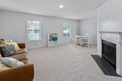 Family room with inviting wood burning fireplace.