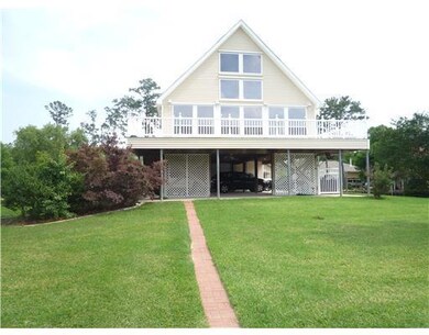 Photo. Closer view of A-Frame cottage with wrap a