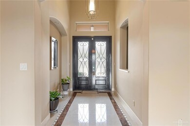 Entrance foyer with tile patterned floors, french doors, and a high ceiling