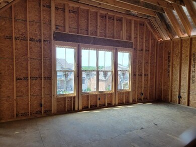 Bonus room is just a few steps up from the rest of the main living area. Beautiful ceiling lines, and what a great place to watch the 