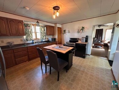Kitchen with appliances with stainless steel finishes, dark countertops, and brown cabinets