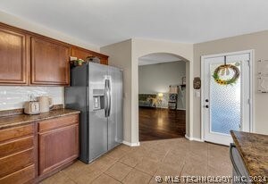 Open kitchen with stainless appliances that remain