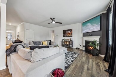 Living room with crown molding, LVP-type flooring,
