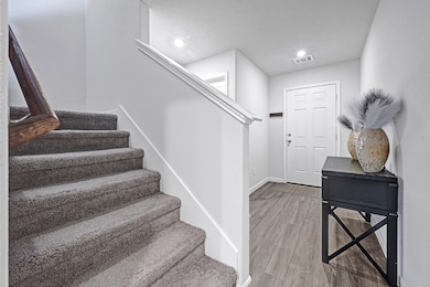 A bright and welcoming entryway with wood-look flo