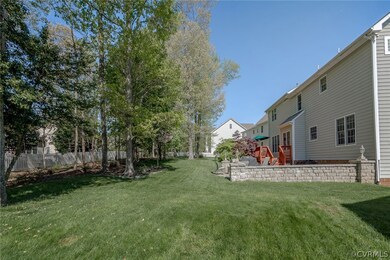 Gorgeous Backyard features a Paver Stone Patio, Sitting Walls, and Firepit(2007) and Large Rear Deck!