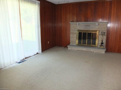 Family room with crown molding and fireplace.