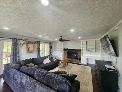 Living room with ornamental molding, dark hardwood