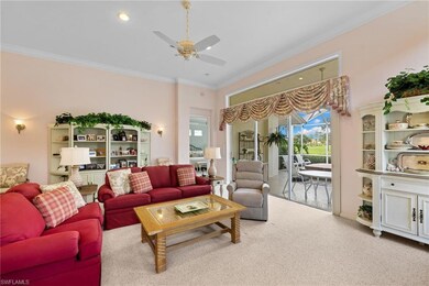 Living room with ornamental molding, carpet, ceiling fan, and recessed lighting