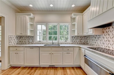 Kitchen with open shelves, a warming drawer, white cabinetry, recessed lighting, and light wood-style floors