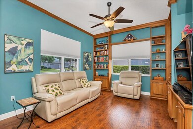 LIVING ROOM WITH BUILT-IN CABINETS AND BOOK SHELVE