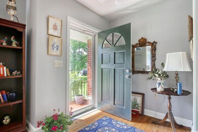 Entrance foyer with wood finished floors and baseboards