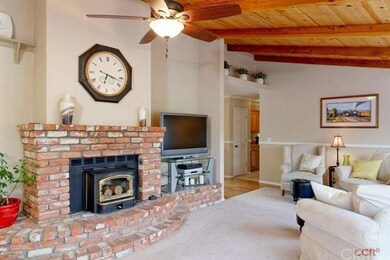 A warm fireplace insert and brick hearth complimen