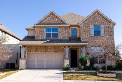 View of front of home with cooling unit and a garage