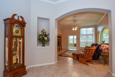 As you enter you ALSO see formal living/family room. Notice the beautiful arches, natural colors on walls and TILE throughout this space.