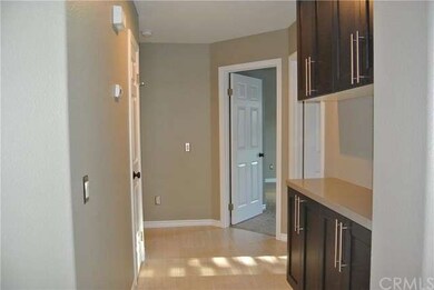 Hallway with new rich, dark cabinets