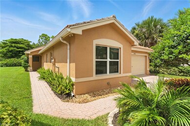 View of property exterior with a garage, stucco siding, driveway, and a lawn