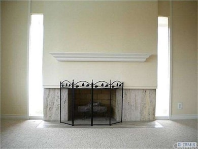 Living room fireplace with stone surround.