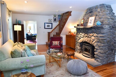 Living Room with fieldstone fireplace, wood burnin