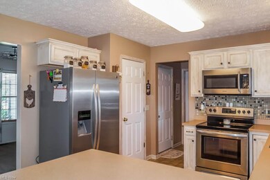The kitchen has stainless steel appliances and a pantry!