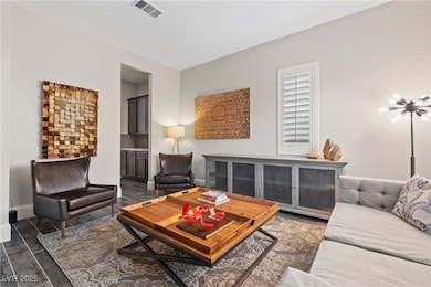 Living area with wood finished floors, visible ven
