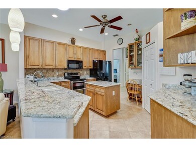 Kitchen with granite counters, tile backsplash, bu