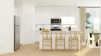 Kitchen featuring backsplash, appliances with stai