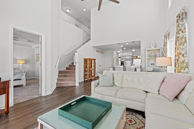 Living room featuring visible vents, wood finished