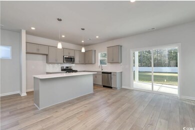 Kitchen featuring a center island, pendant lightin