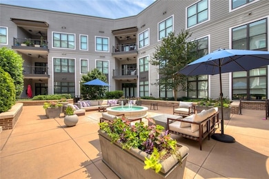 View of property's community featuring a patio area and an outdoor hangout area